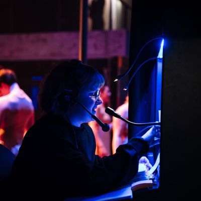 Deputy Stage Manager working at a cueing desk at the side of the stage